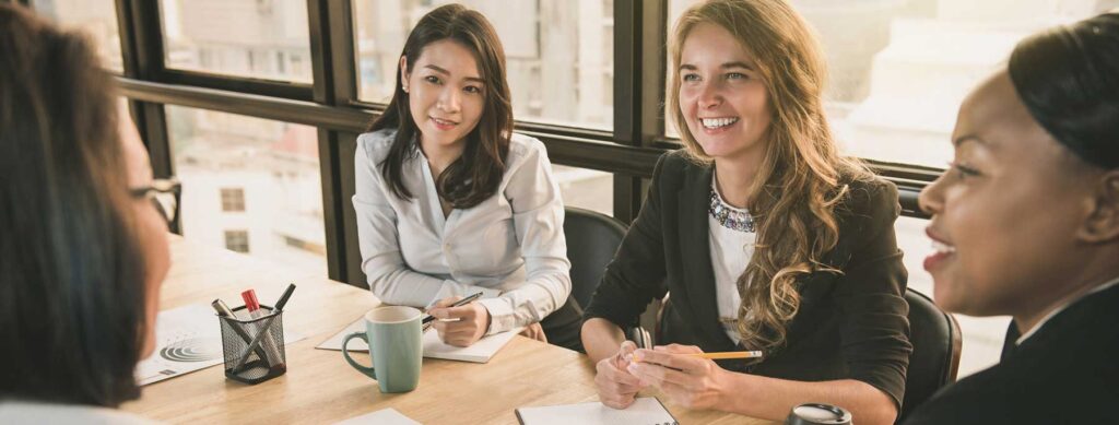 group of women talking around a table