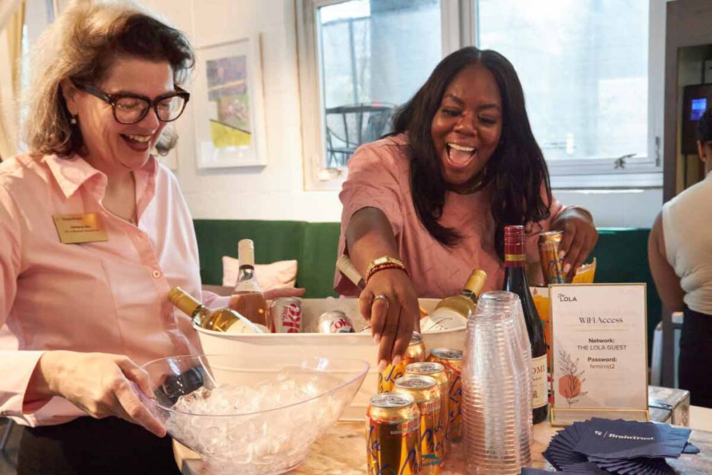 Women laughing together at beverage table